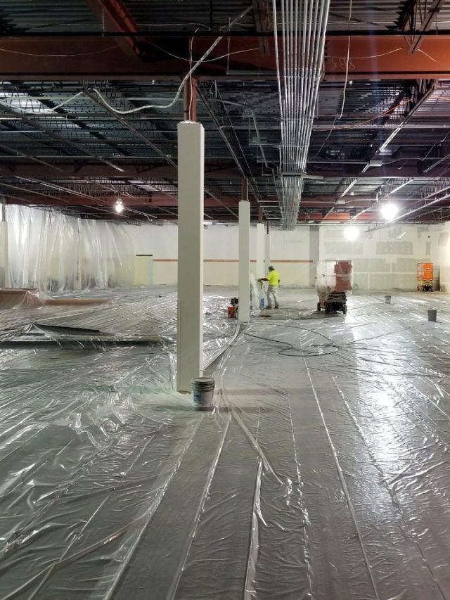 a person preparing a warehouse to paint
